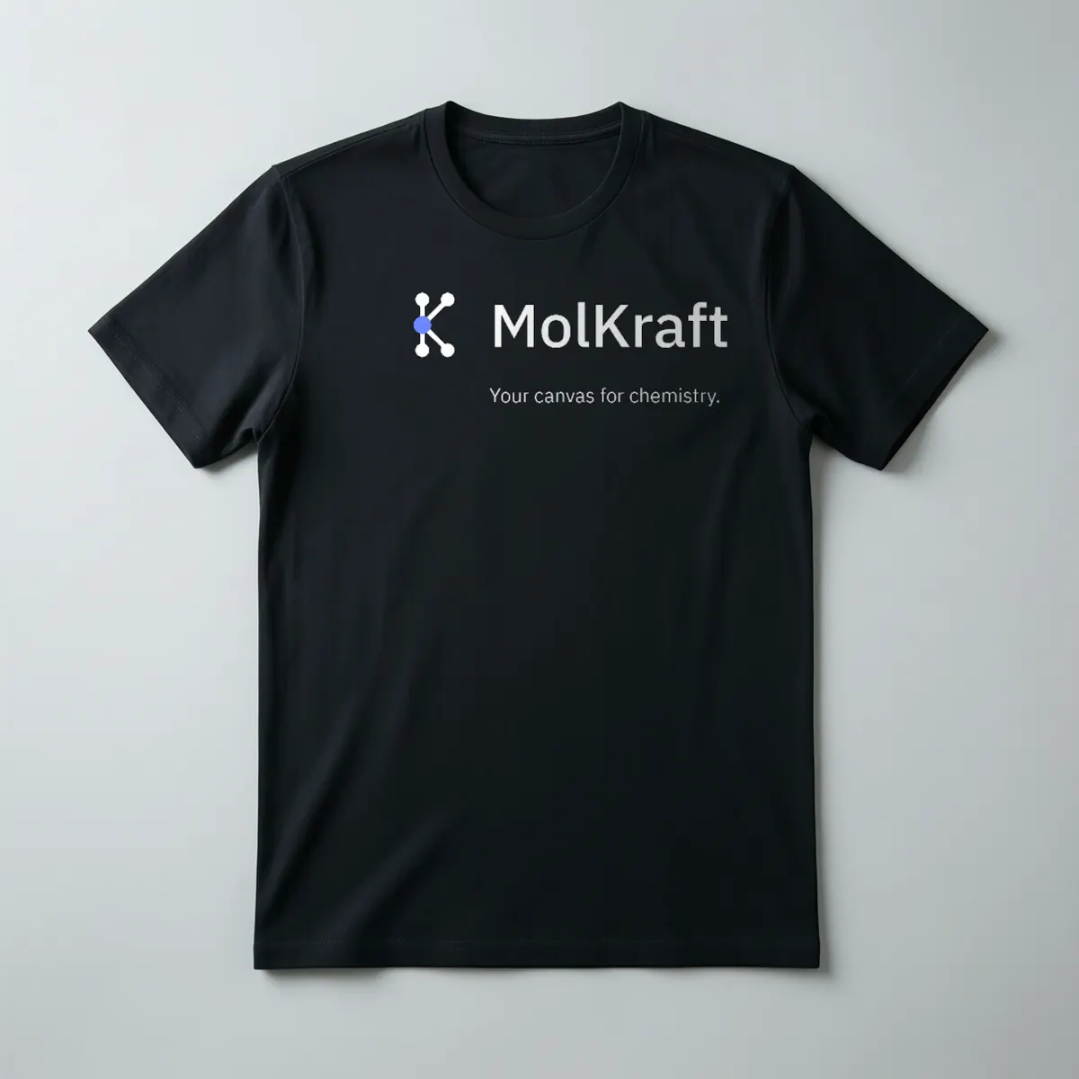 A black t-shirt printed with the MolKraft logo and Your canvas for chemistry.